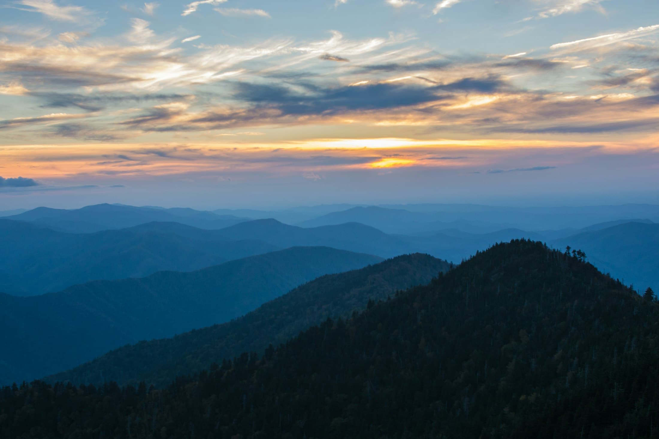 Layered mountain ridges receding into dusk