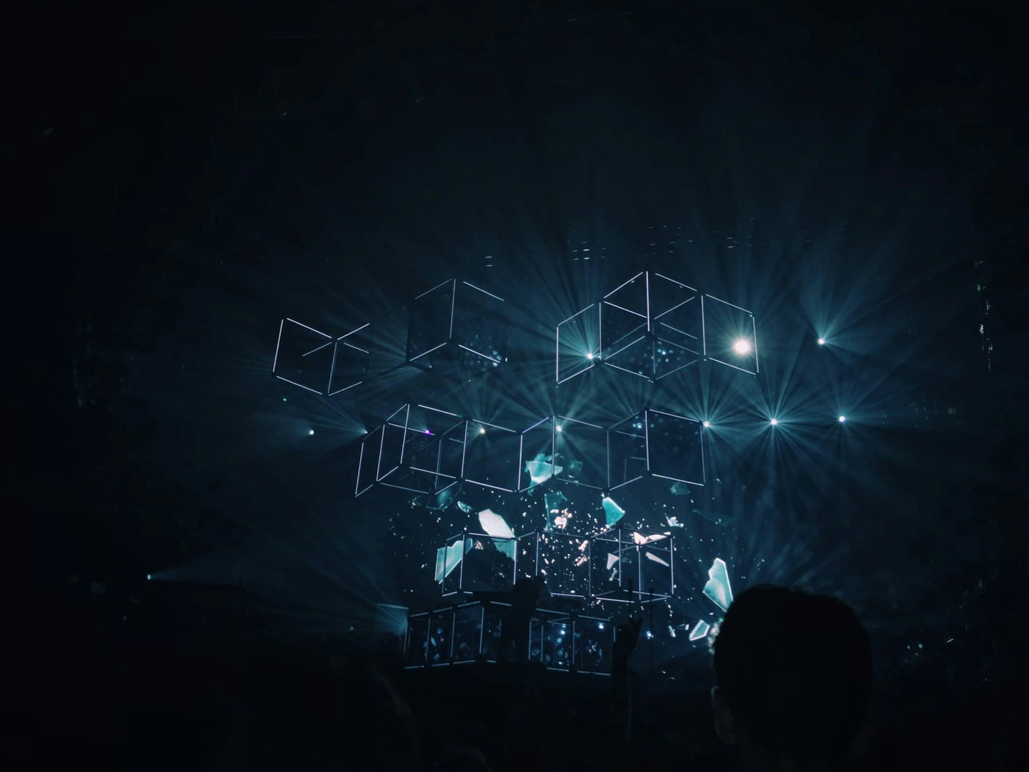 A darkened stage lit by suspended light frames